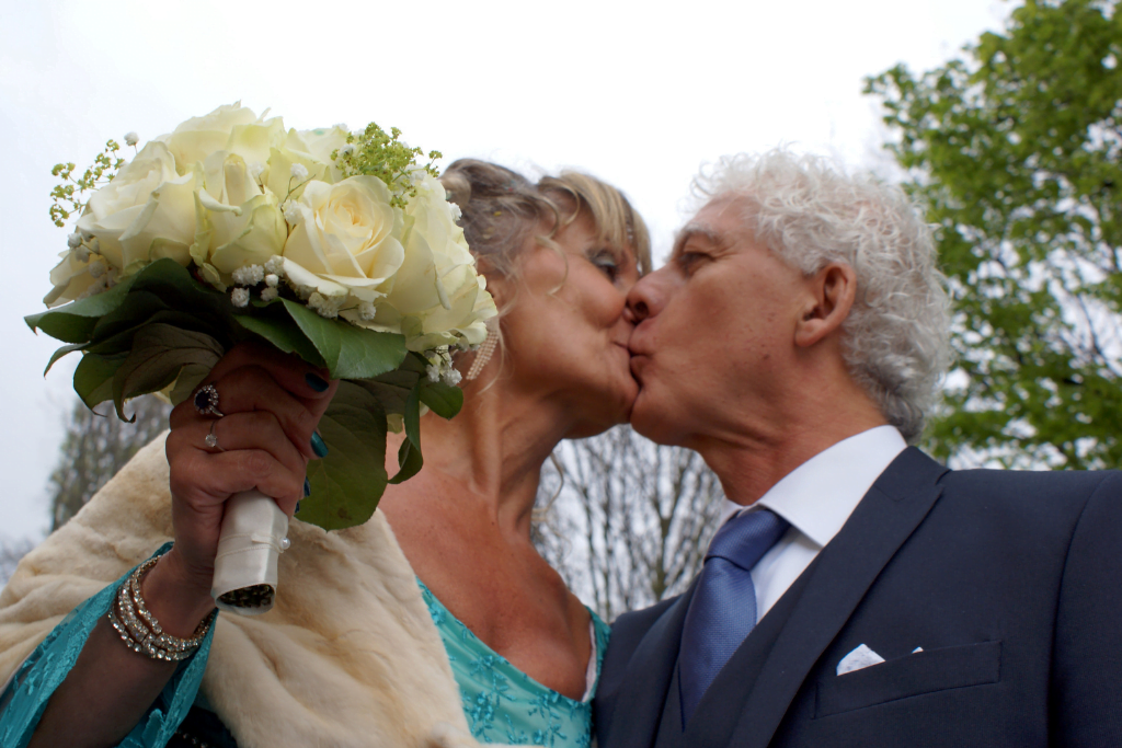 husband and wife kissing on their wedding day