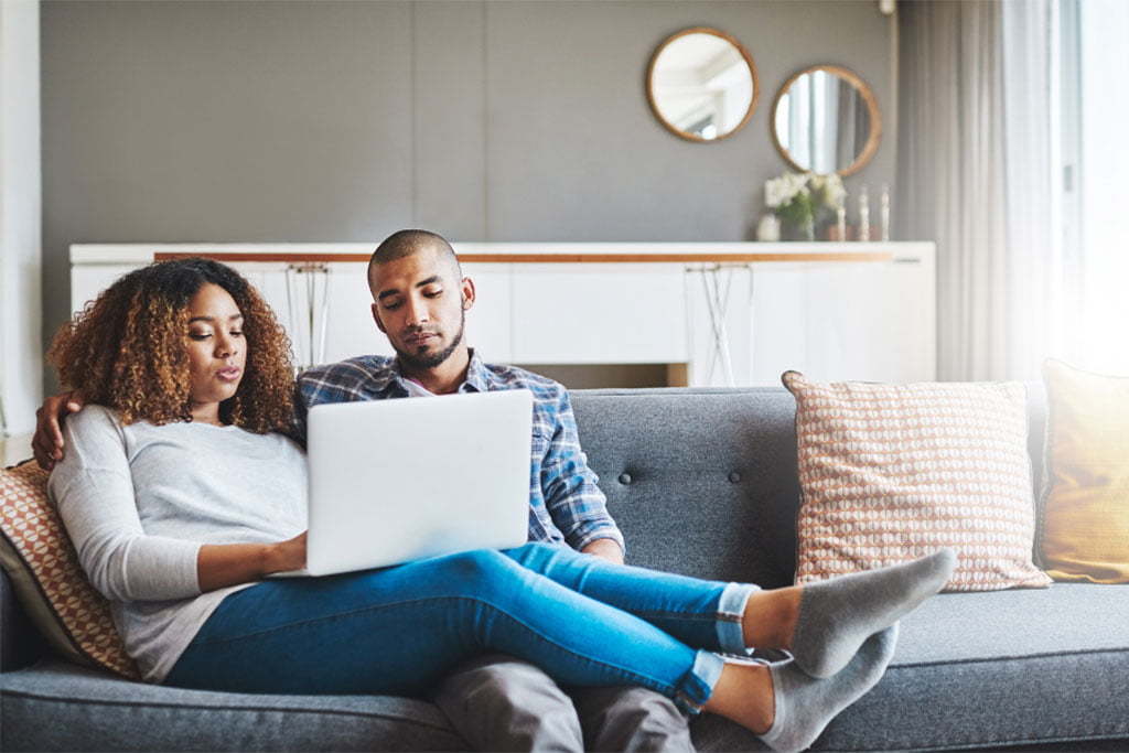 Question to ask your spouse, man and women looking on a laptop