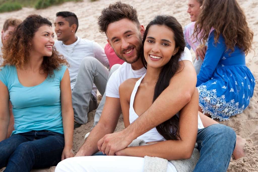 Group of friends hanging out on the beach