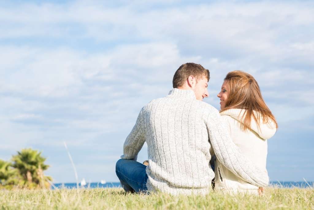 lovers sitting at the sea site