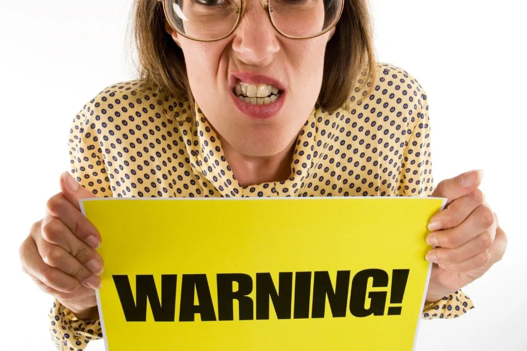 Woman with a warning sign
