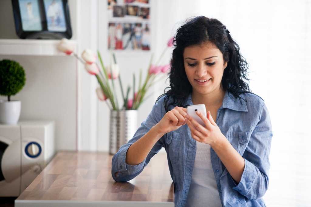 A young beautiful women texting with her mobile phone