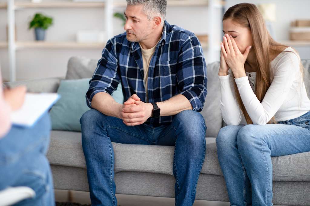 A couple seeking help from a professional psychologist in her office