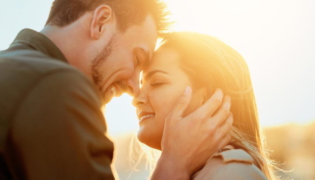 A couple hugging tightly, expressing their love and affection for each other.